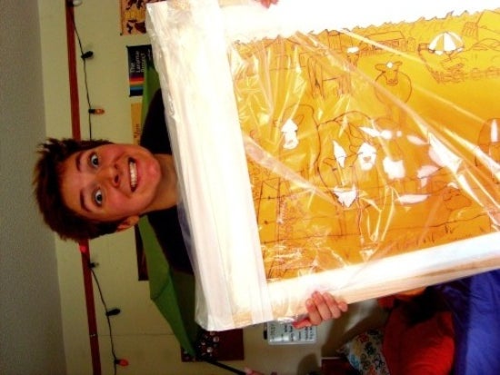 A person excitedly clutching a Matisse painting wrapped in plastic