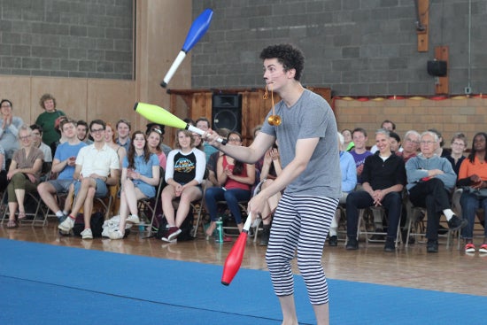 A performer juggles 