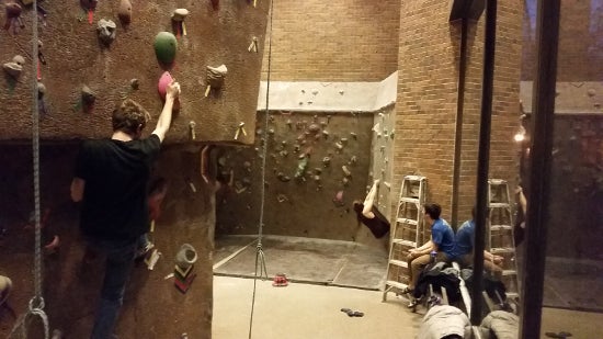 A climber begins to descend a wall