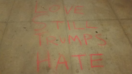 "love still trumps hate" chalked on the sidewalk 
