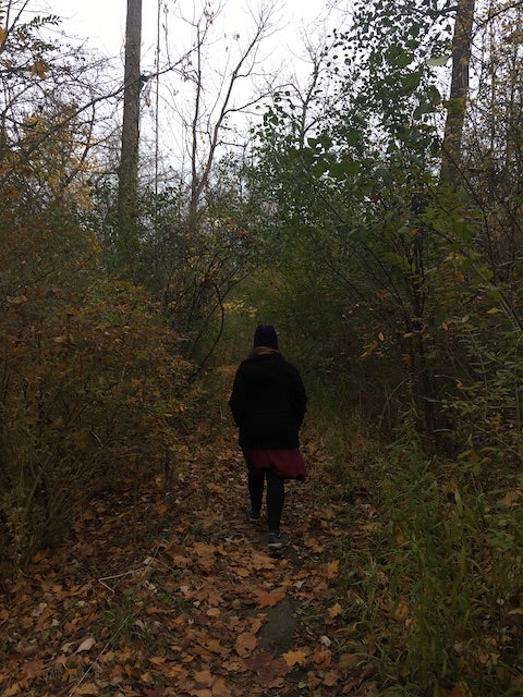 My mom walking along a tree-lined path