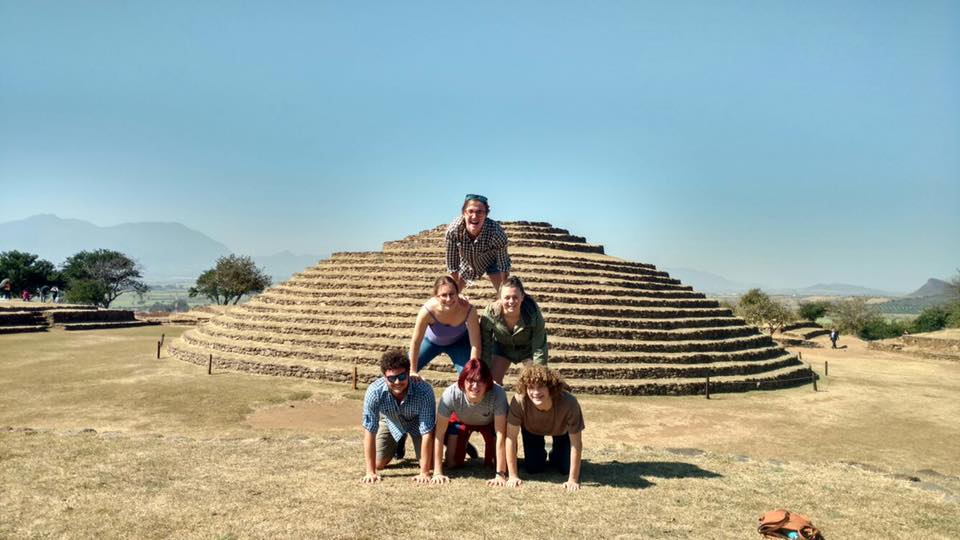 A pyramid of students in front of a pyramid
