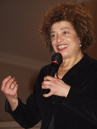 black woman with afro holding mic