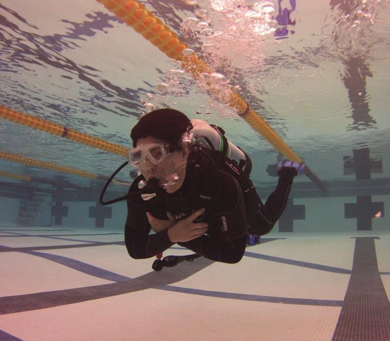 Student scuba diving in a pool