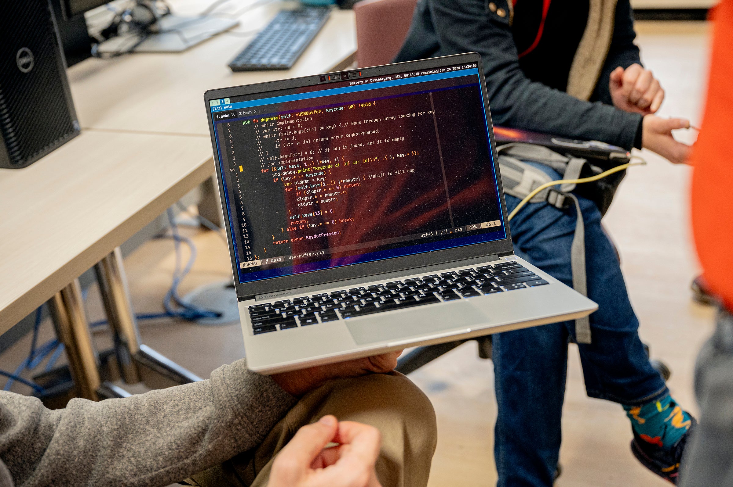 An open laptop displaying computer code.