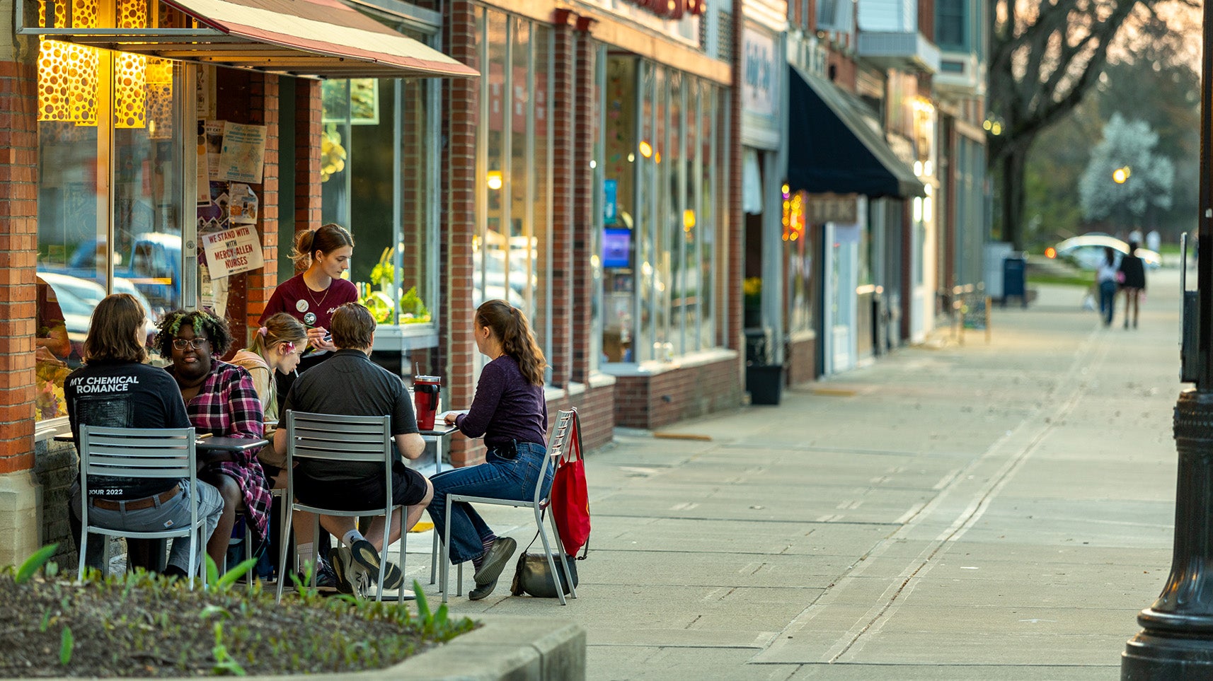 Downtown Oberlin. Group of people sitting at a table outside a local restaurant.