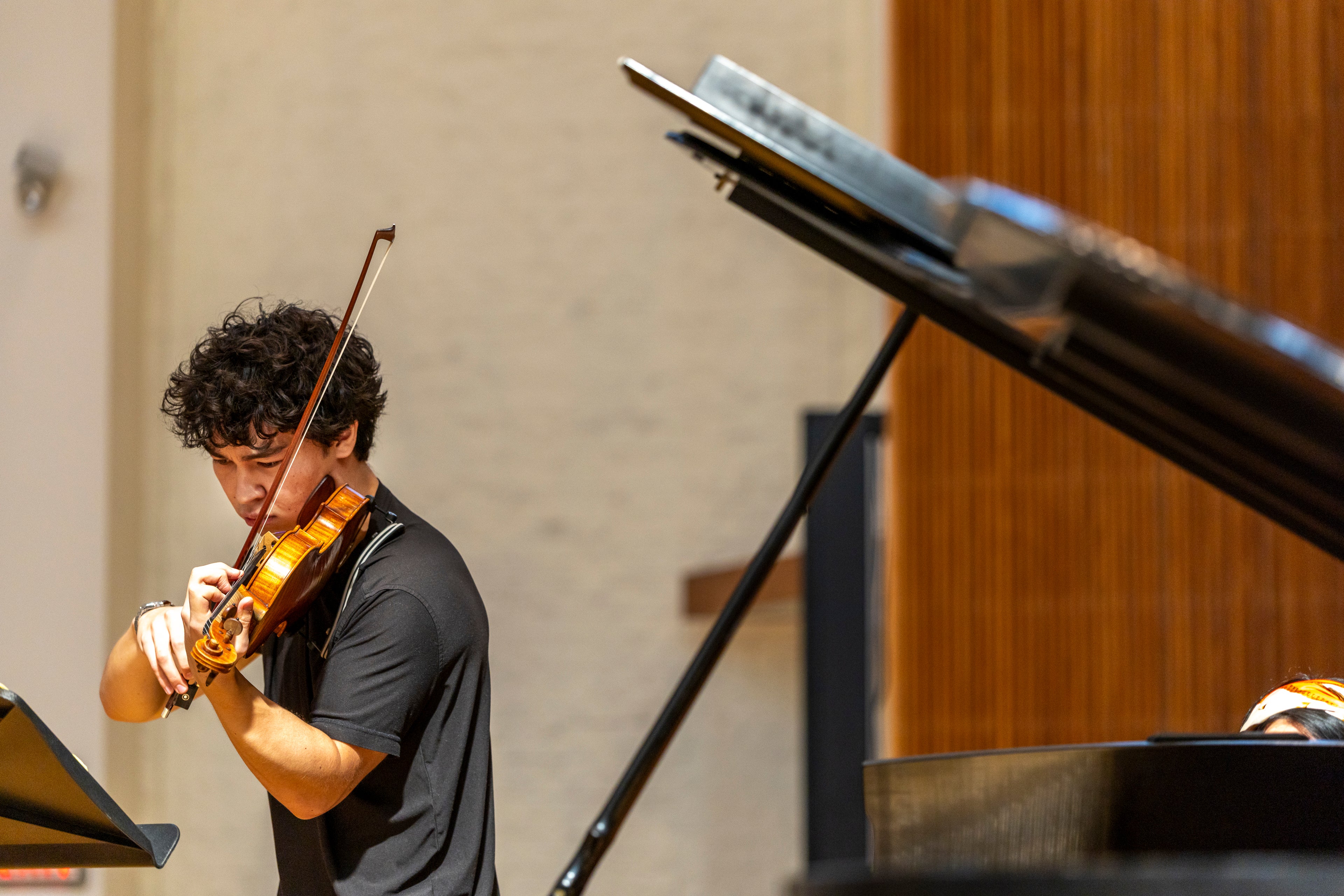 violin student performs on concert stage for workshop