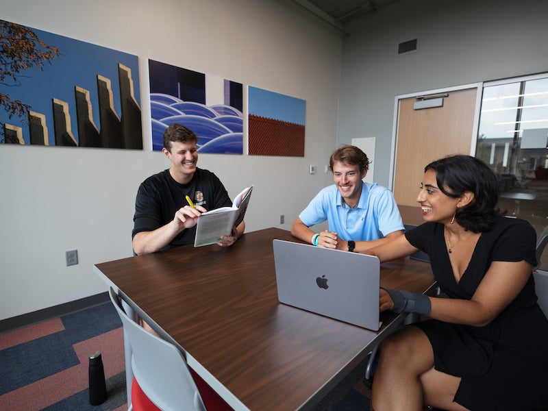students meeting in a huddle space.