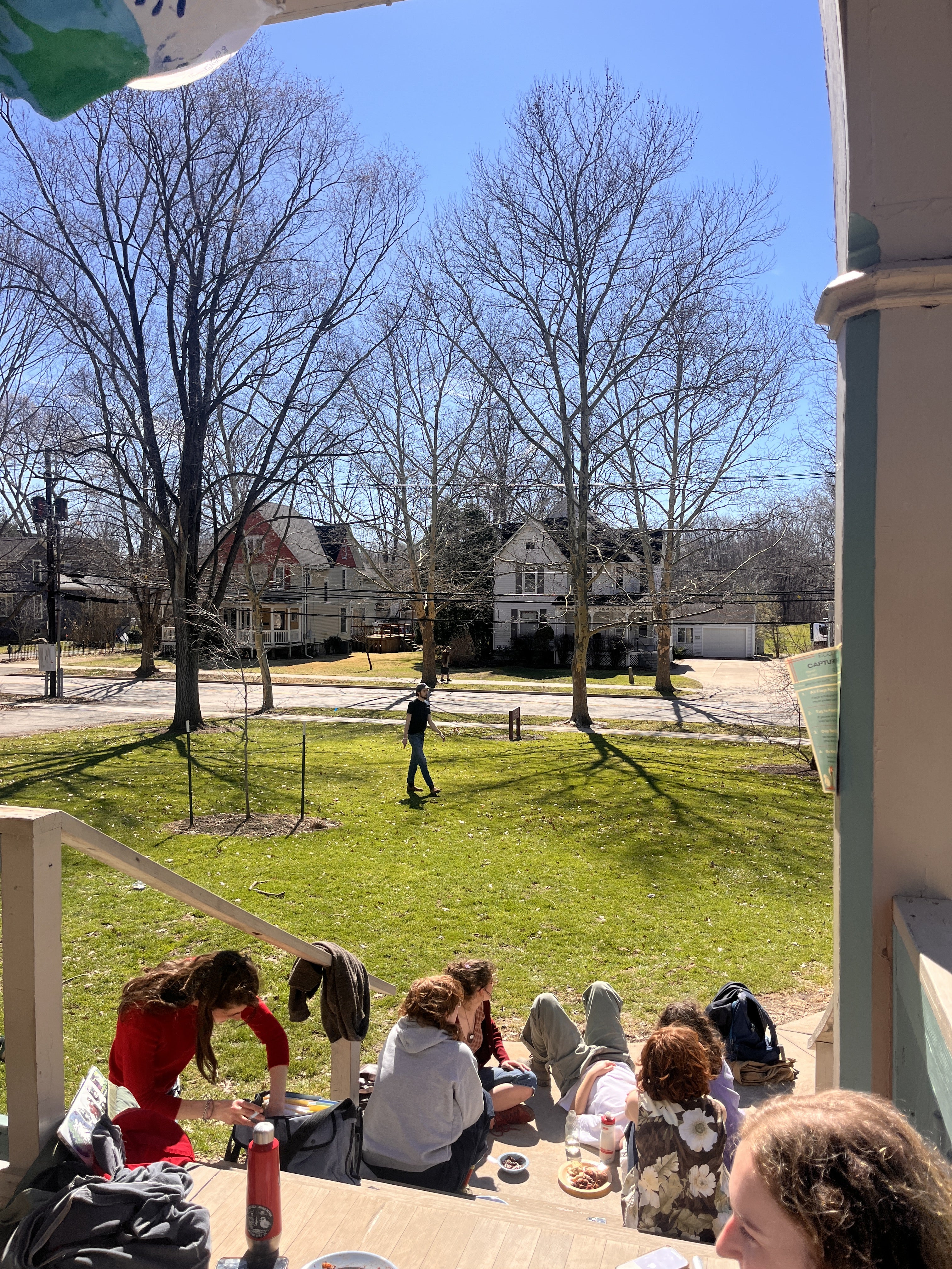 People throwing a frisbee on a lawn