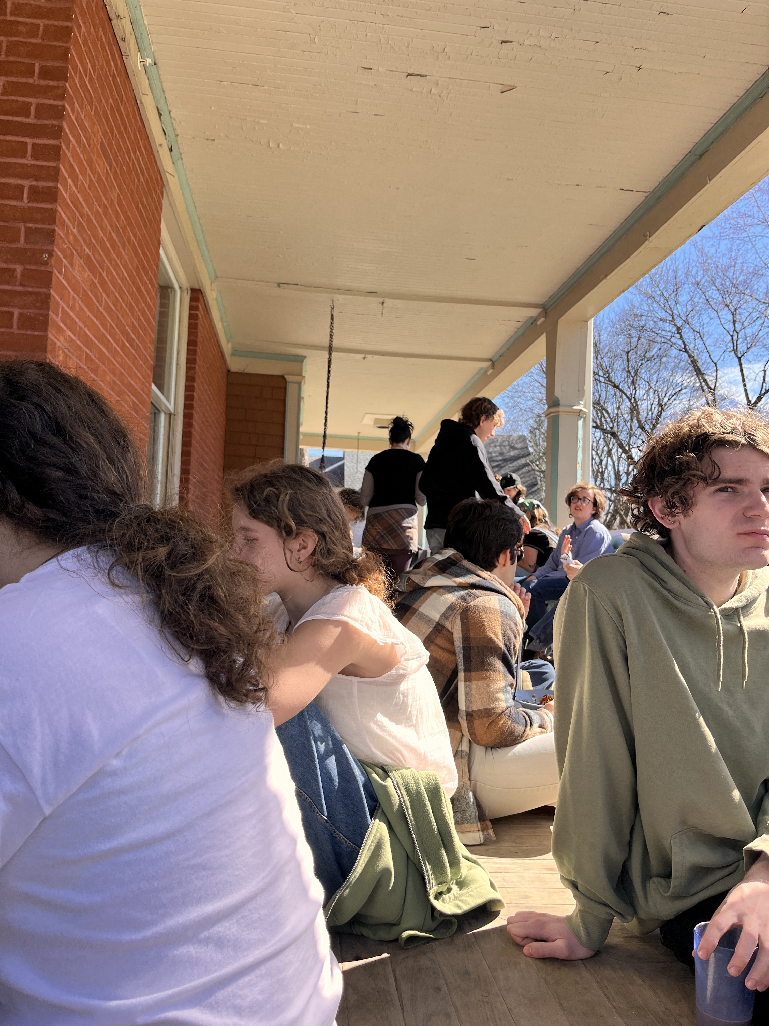 Students eating on a porch