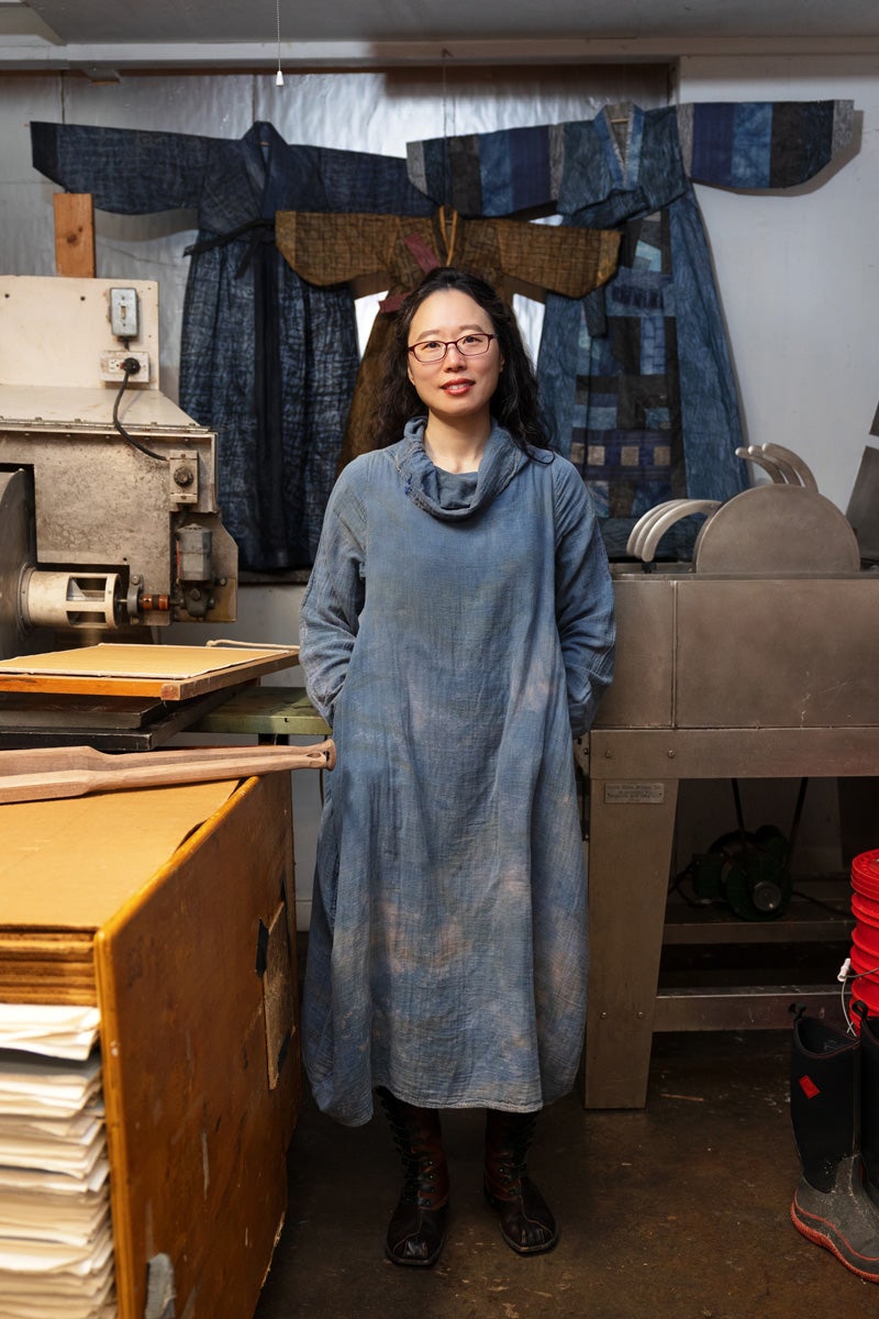 a portrait of Aimee lee with work behind her