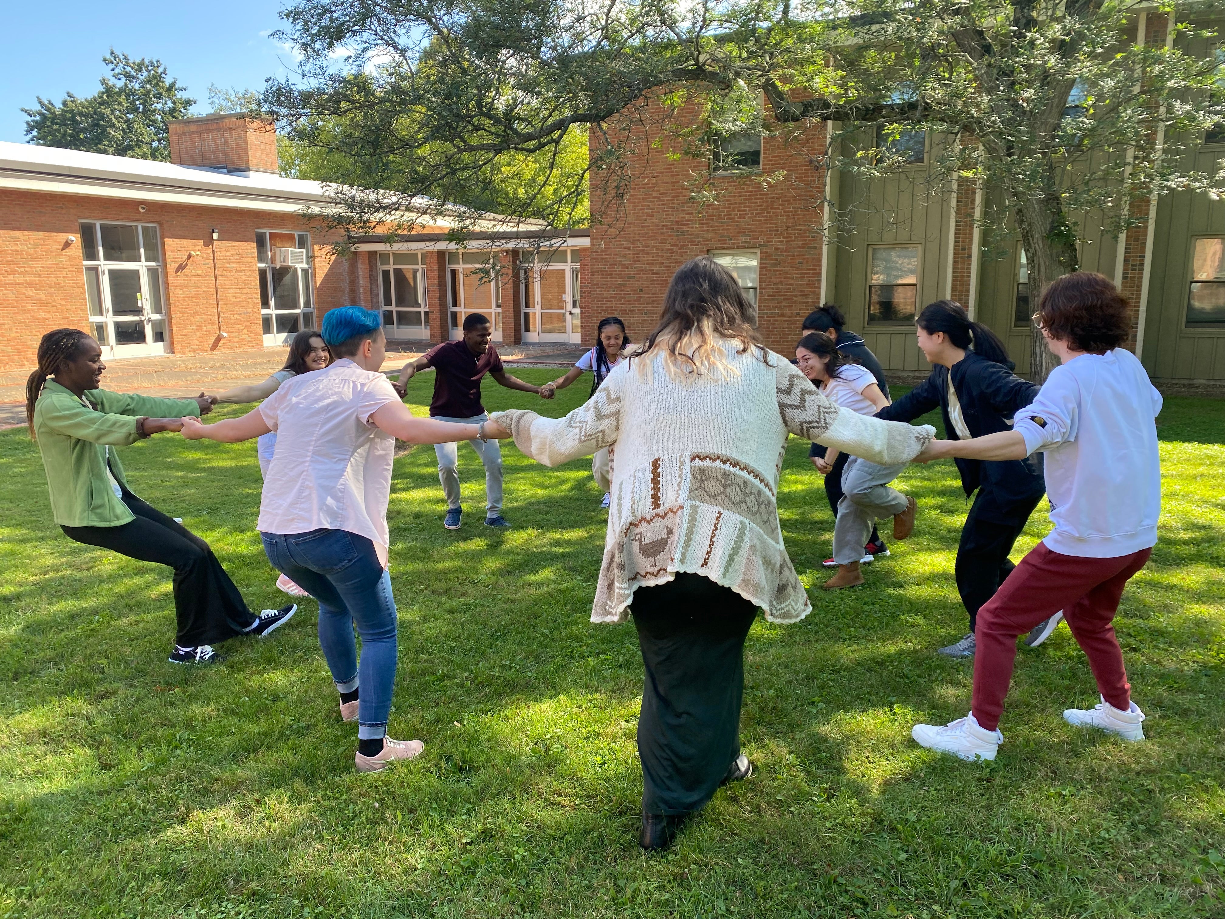 A group of BGM Scholars play a game outside with their Peer Mentors.