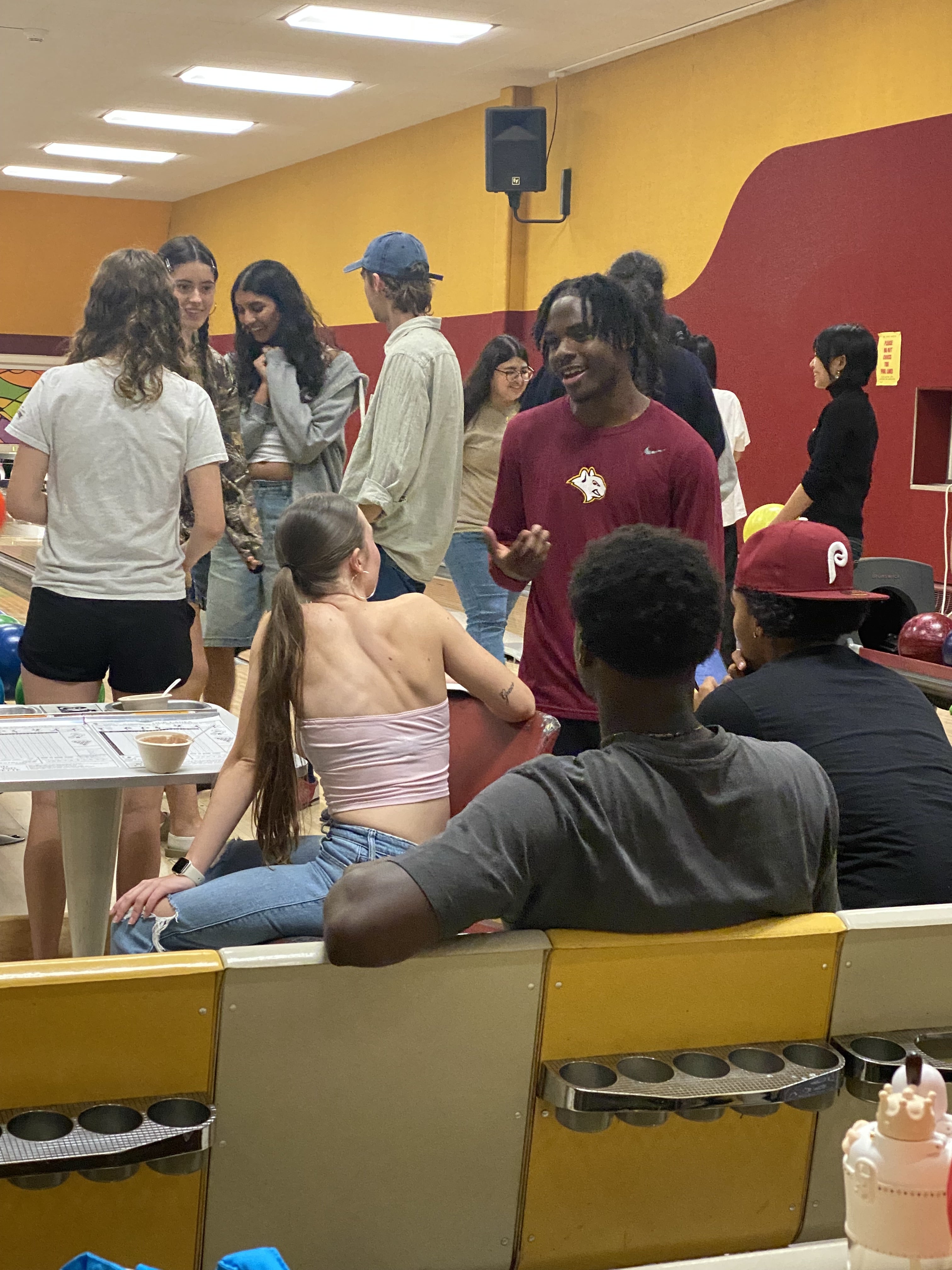 A group of BGM Scholars talk during bowling night at pre-orientation.