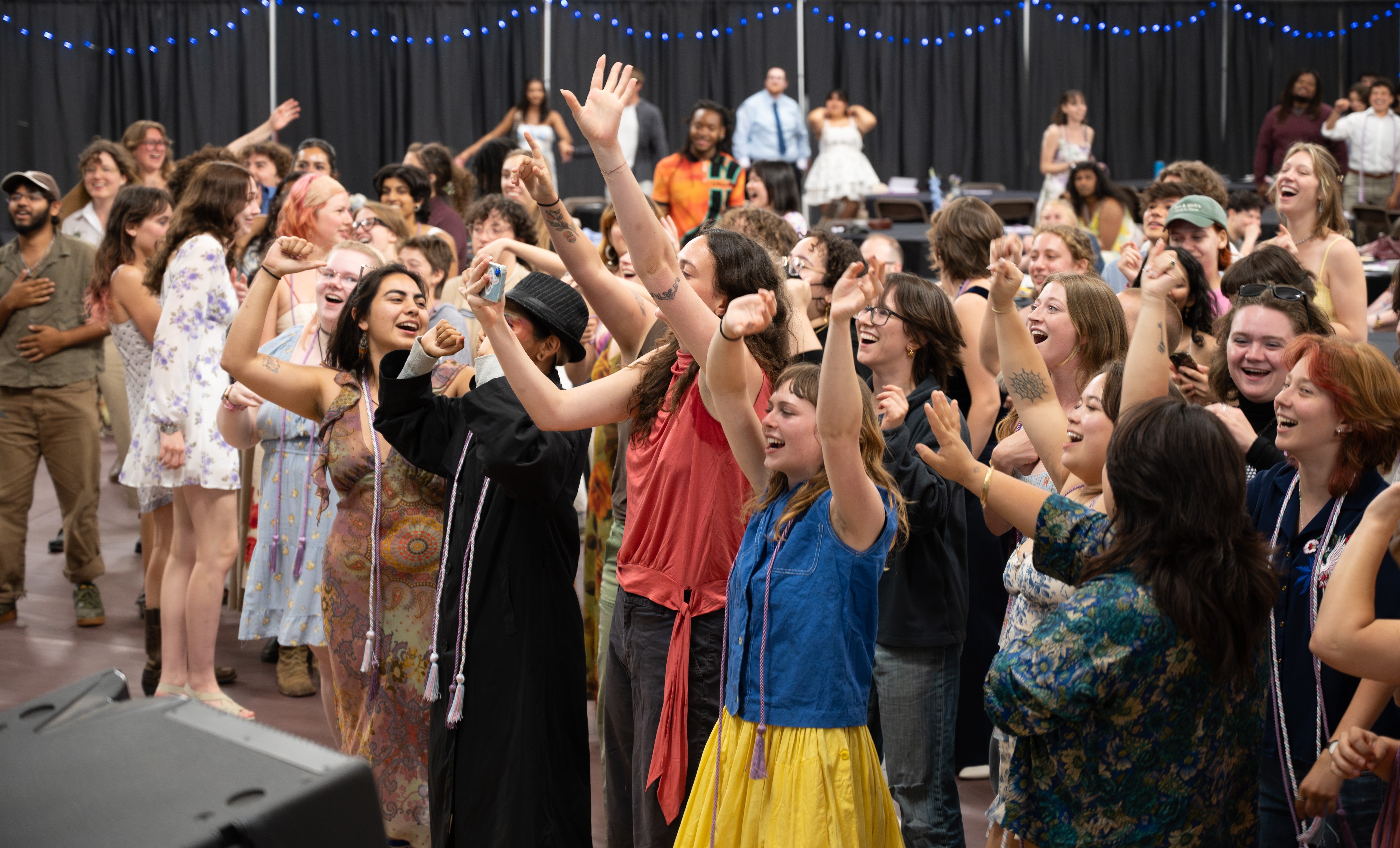 Photo from Lavender Ceremony 2026 where students are enjoying a performance by a graduating student.