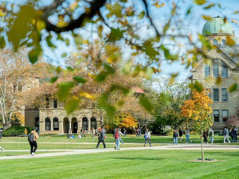 students walking across campus on a fall day.