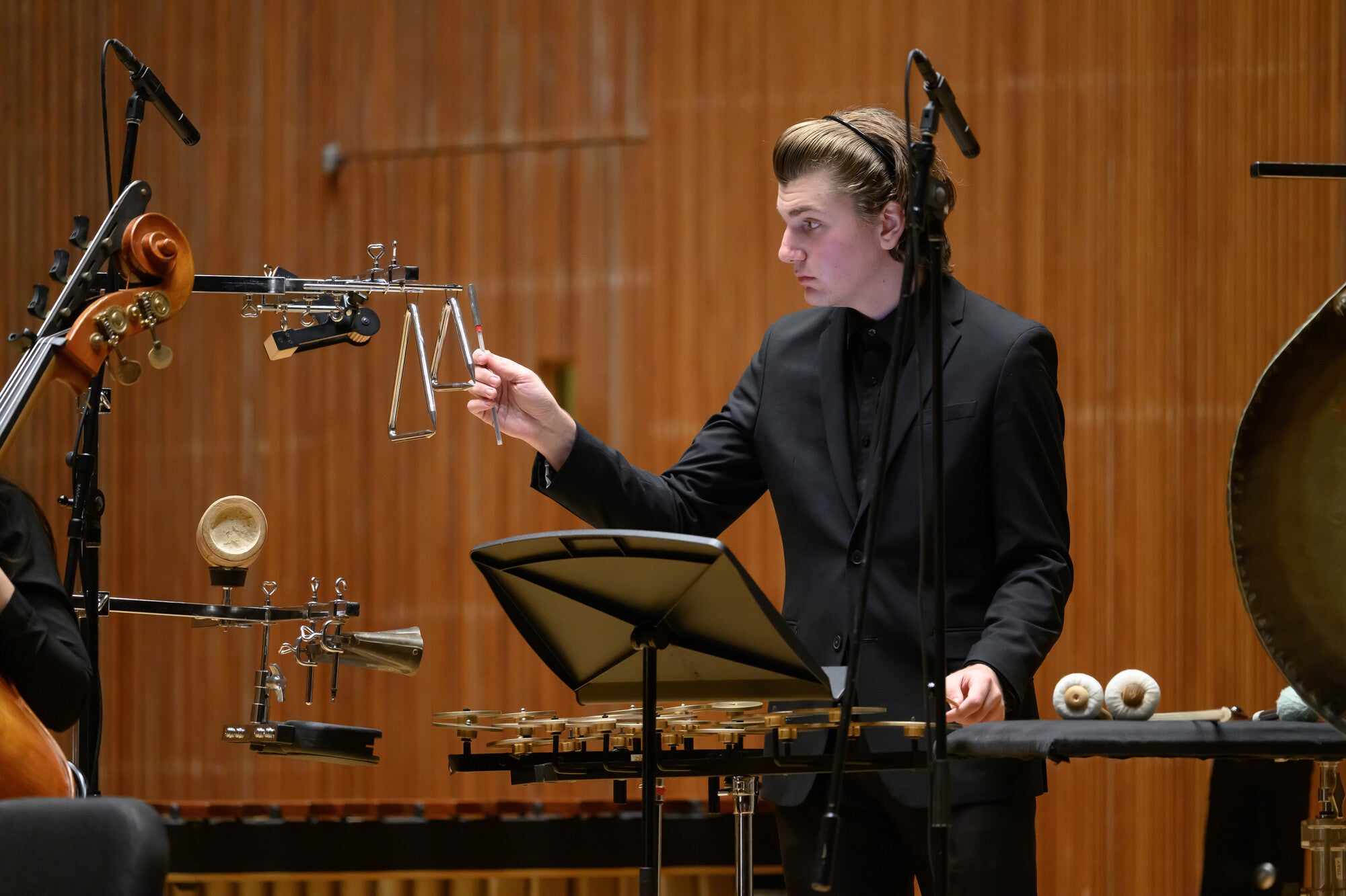 A student performing with a variety of percussion equipment.