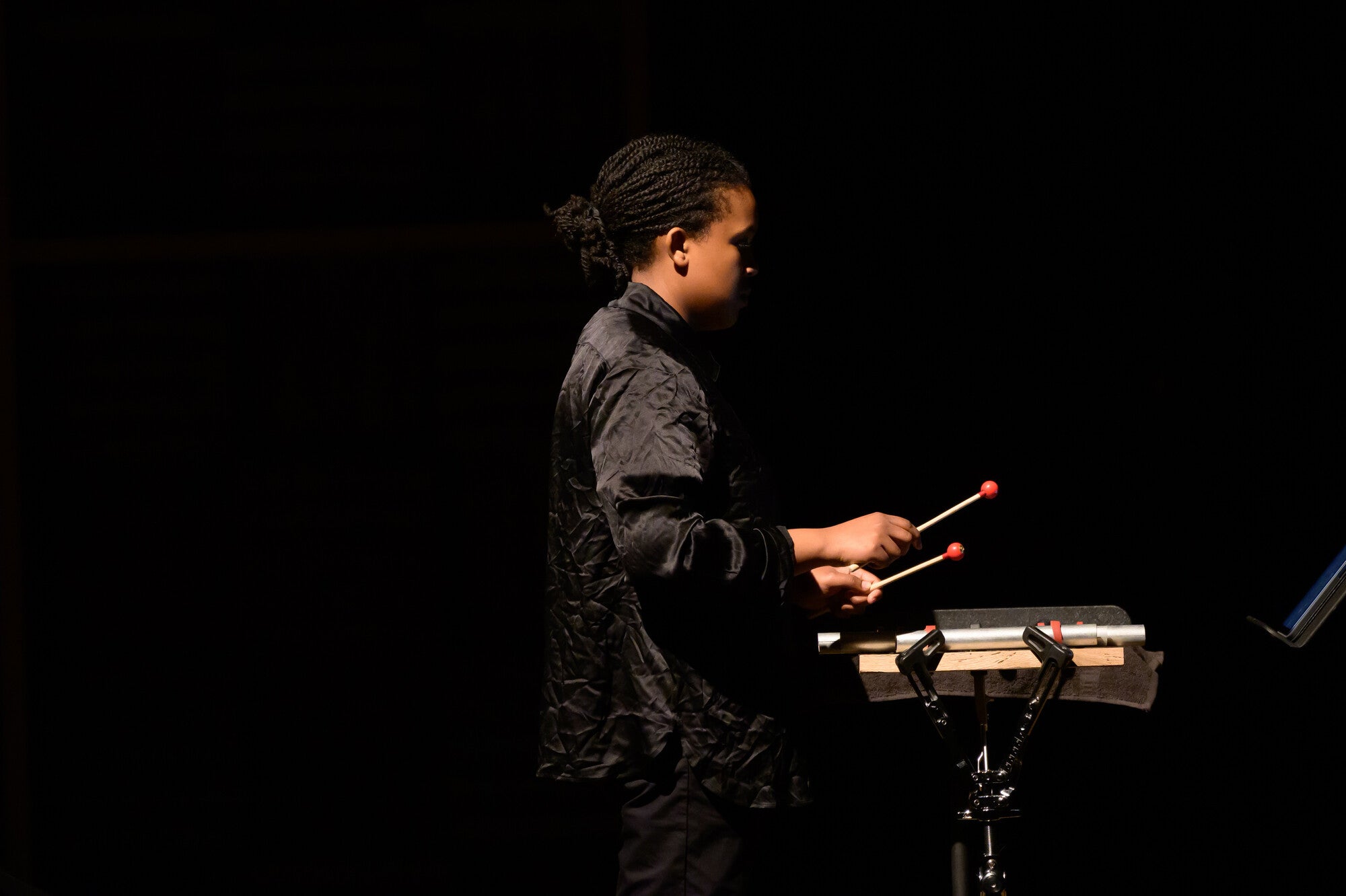 A student performs with percussion equipment.