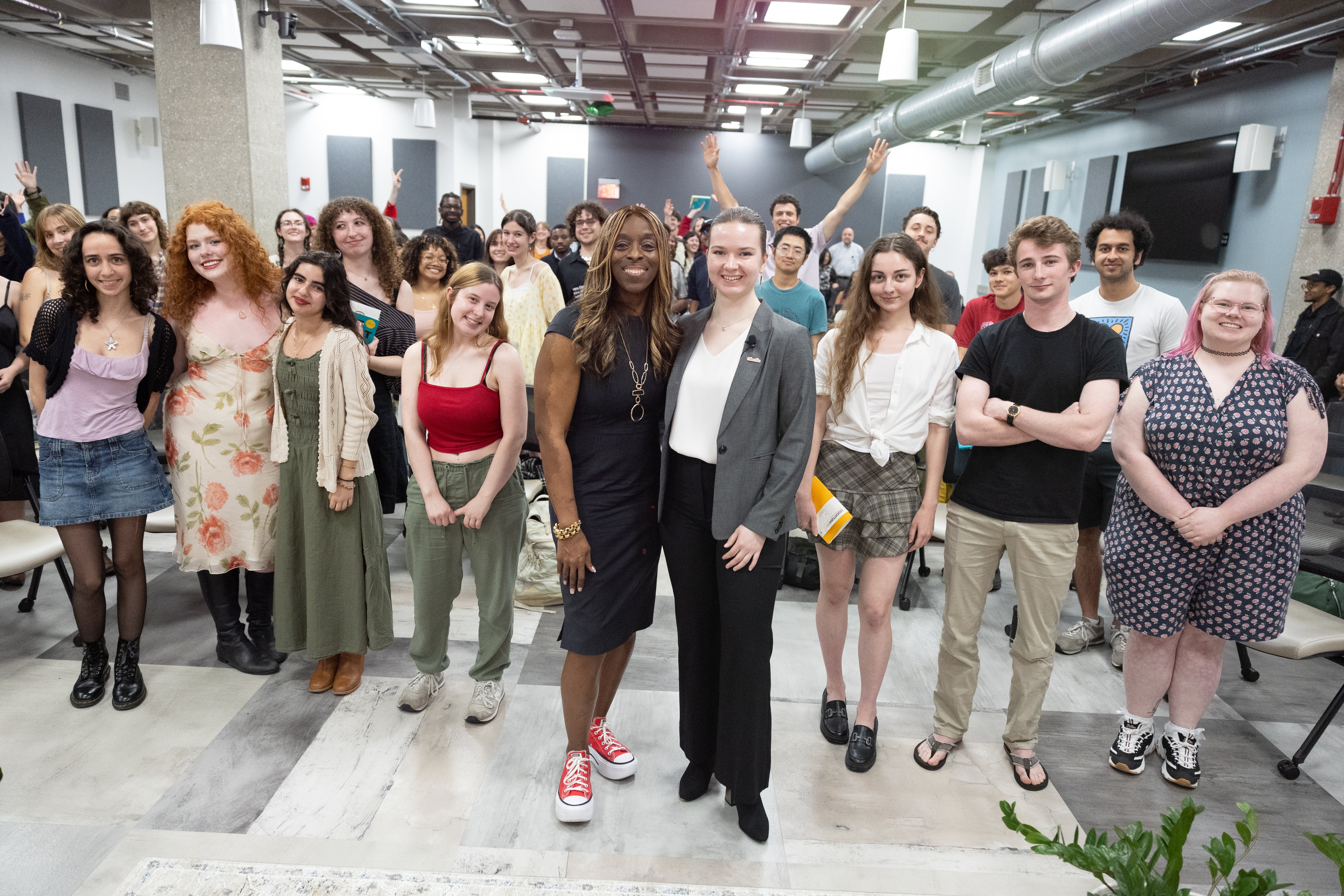President Ambar and Kash Radocha '26 stand in front of a group of celebrating seniors at the First 90 Days on the Job: A Conversation with President Ambar event in April 2026.