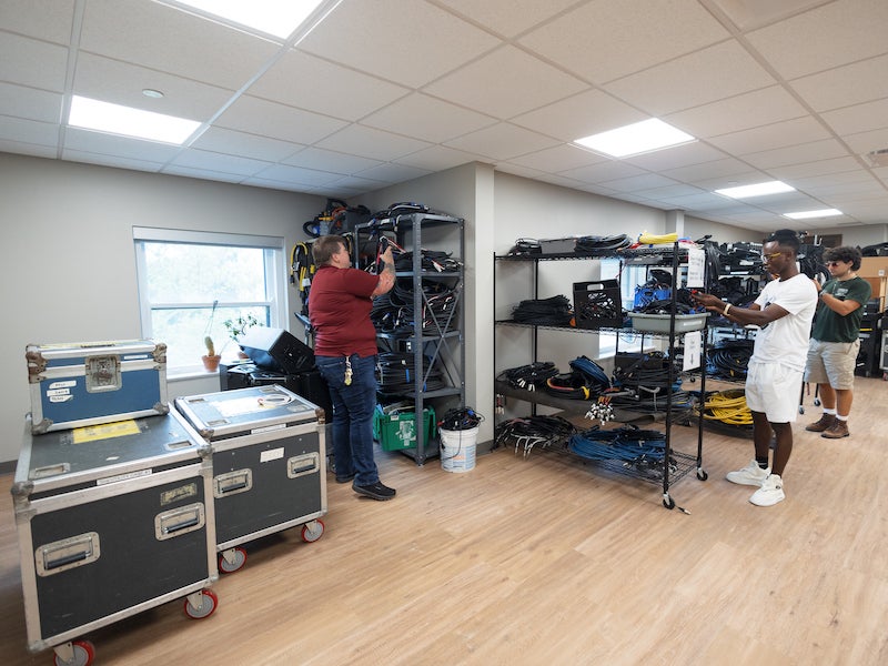 people sorting cables in a room.