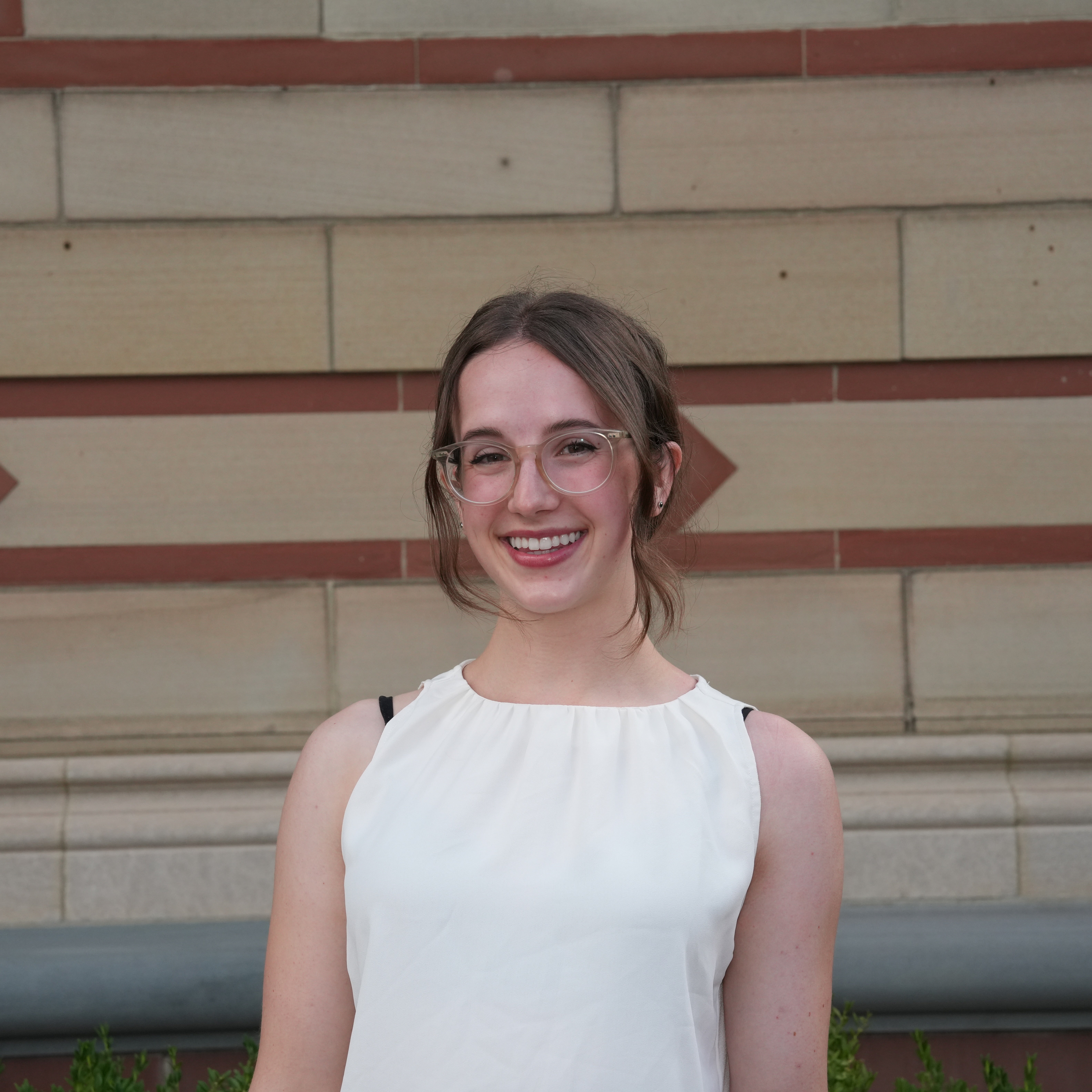 A headshot of a female student in a white shirt.