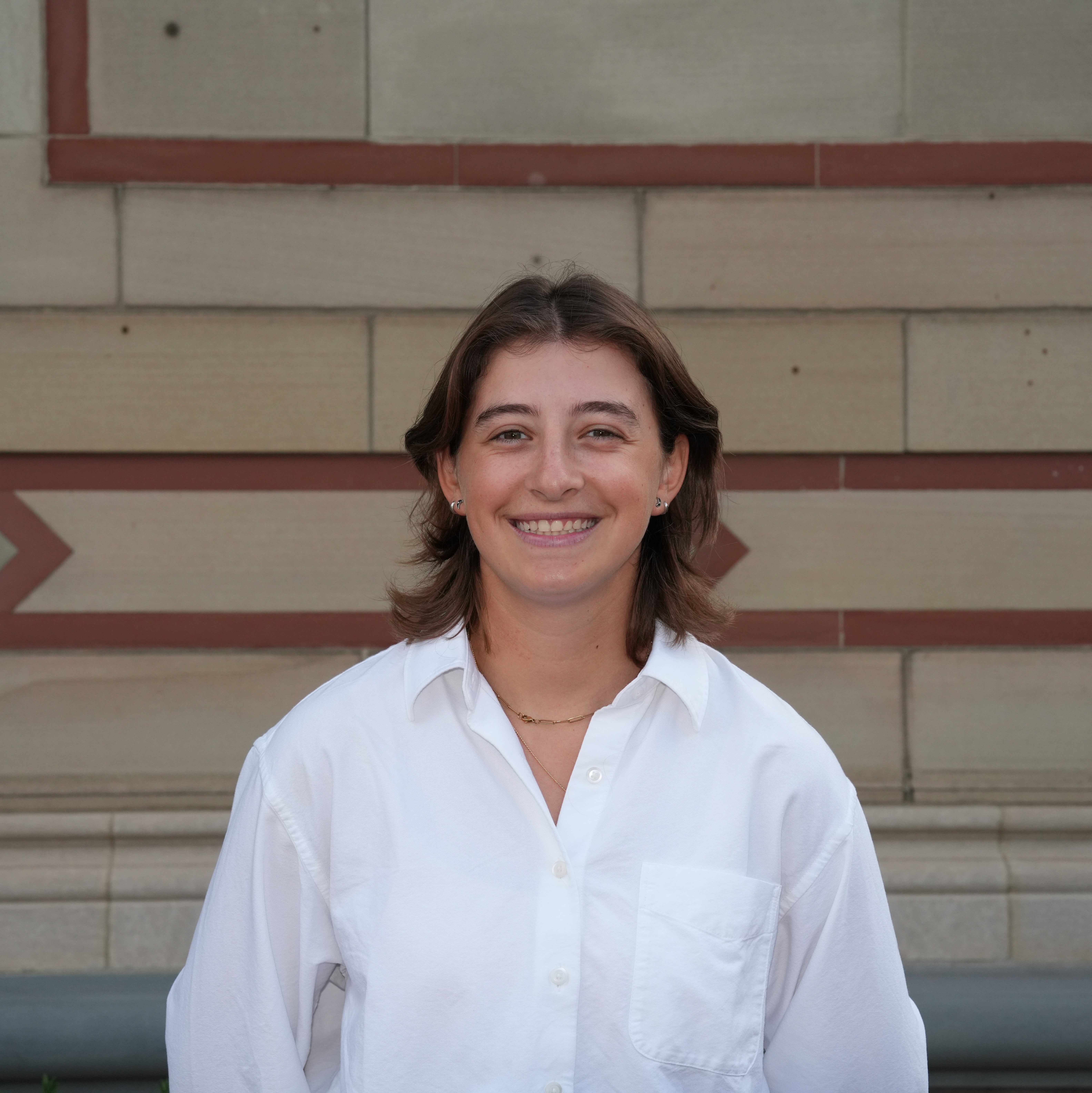 A headshot of a female student wearing a white shirt.