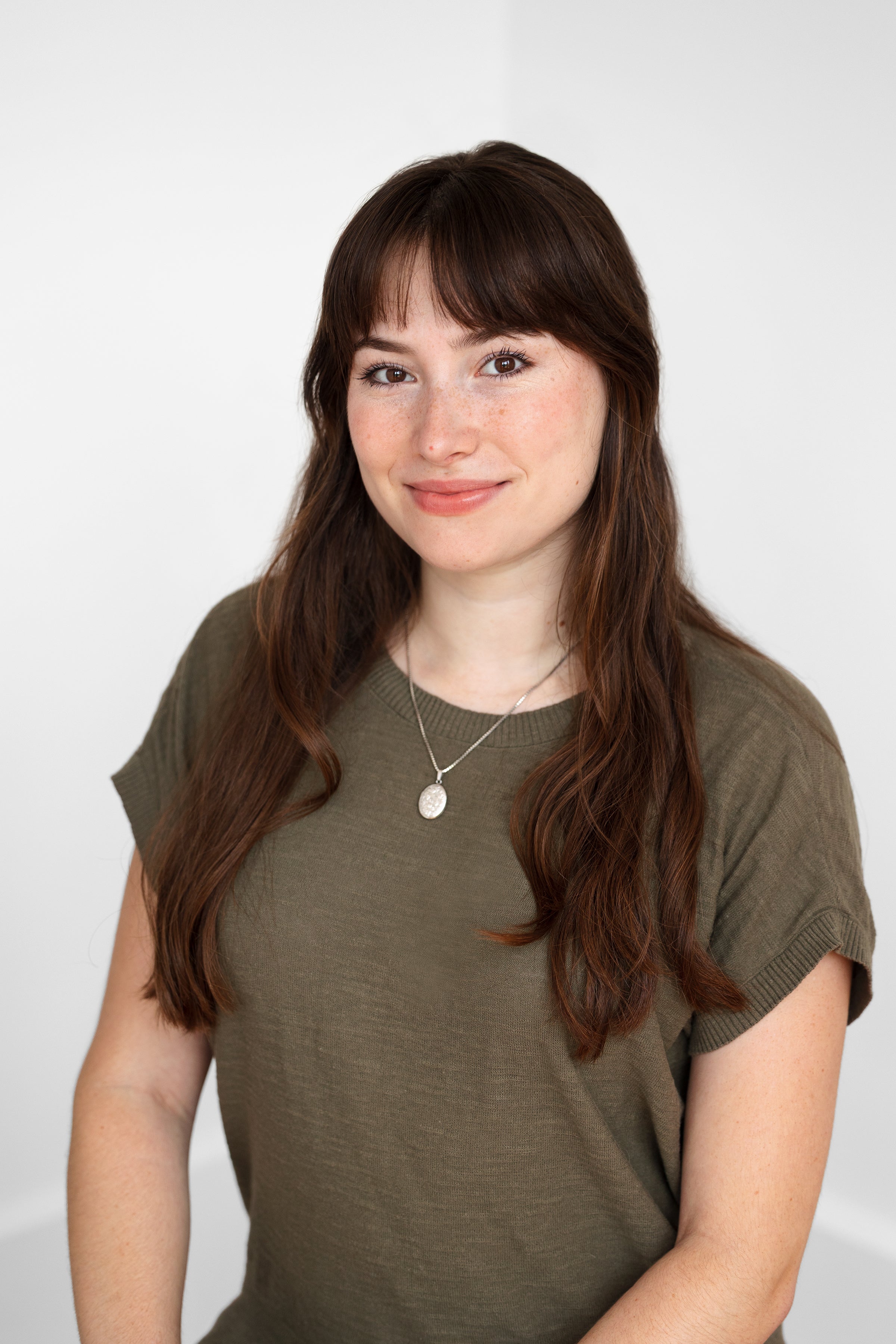 Rayna Moxley wearing an olive green shirt.
