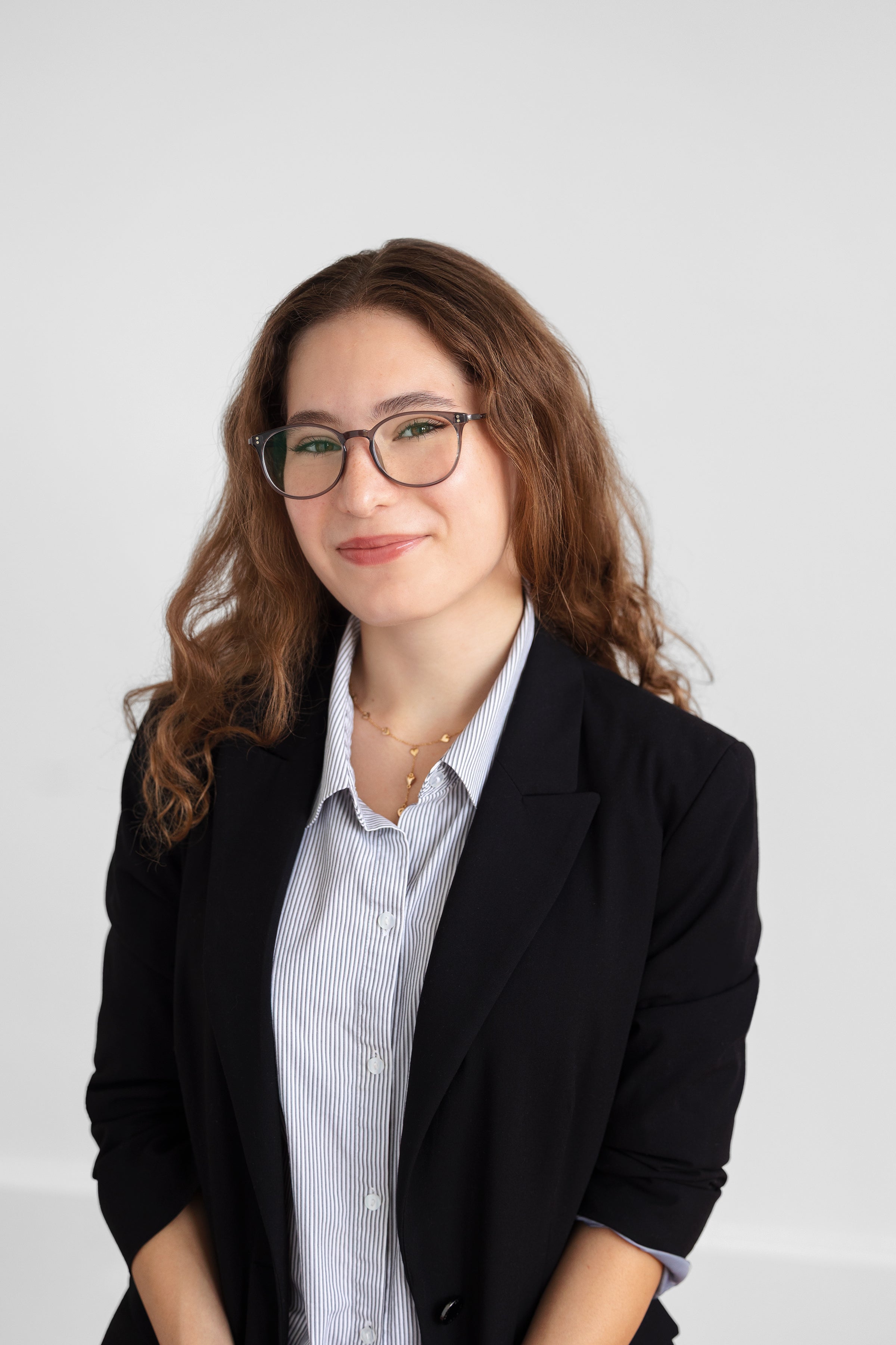 Sofia Munoz wearing a blue blouse and dark suit-jacket.