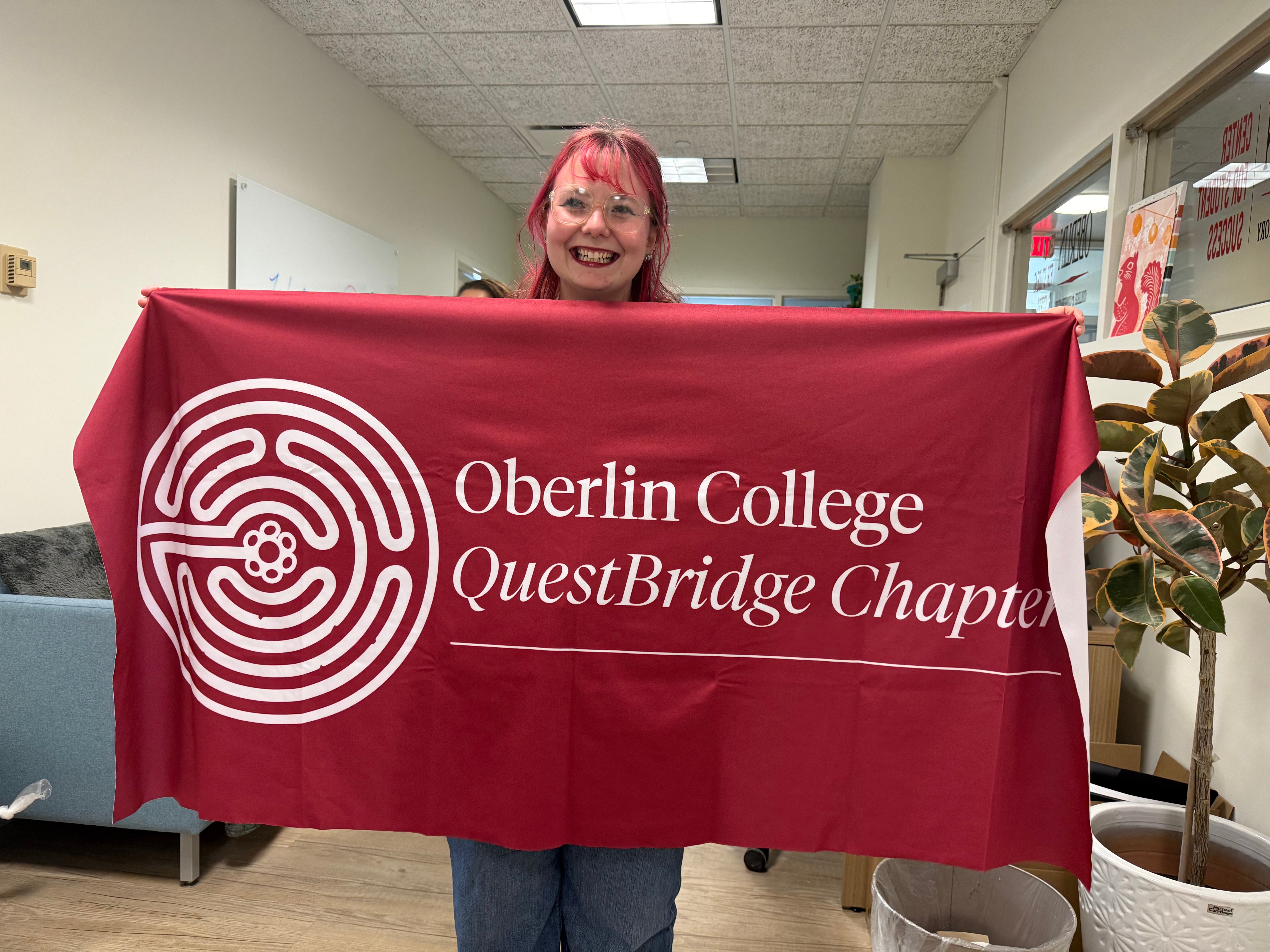 Macy, chapter President, holds up the new chapter banner