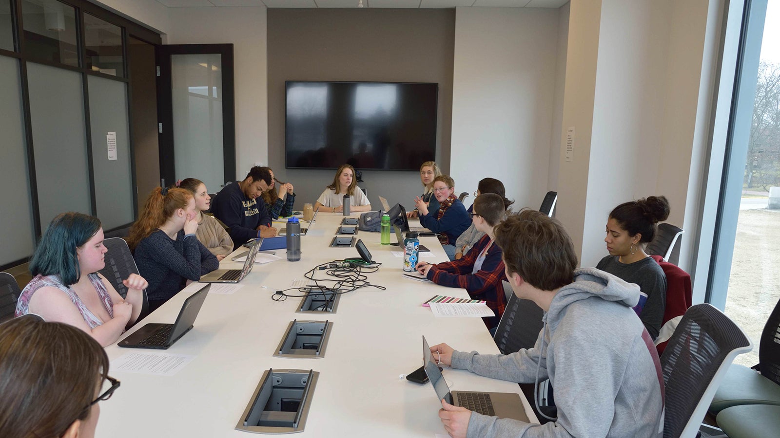 A group of Philosophy students having a discussion in a classroom.