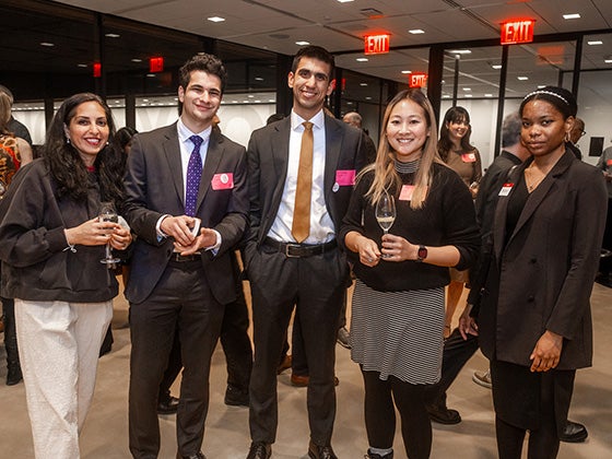 Five sharp-dressed students at an event.