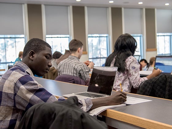 Students work attentively in a classroom.