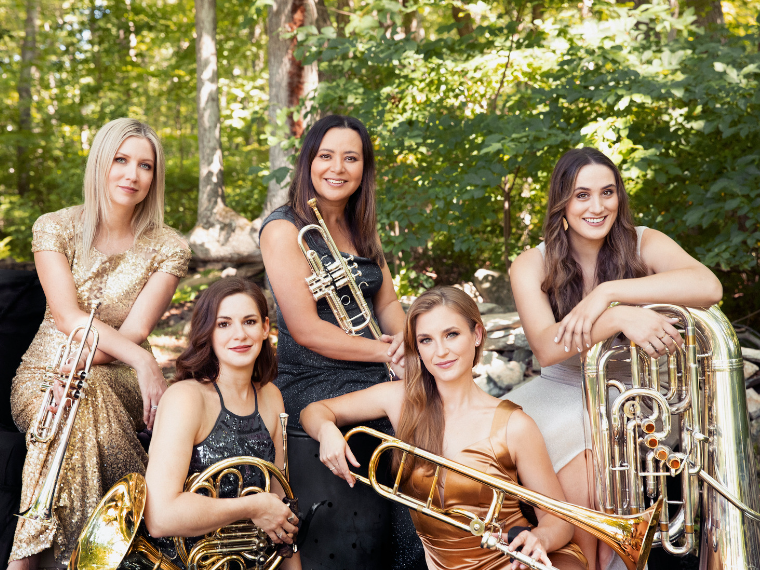 five women holding brass instruments