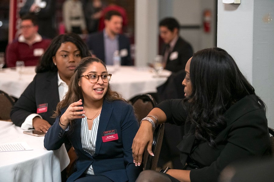 People in business attire having conversations.