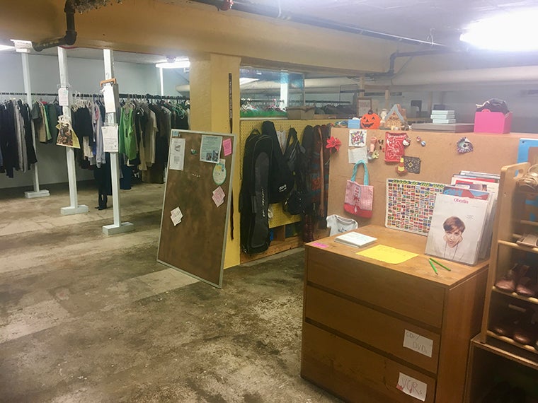 Racks of clothing and a desk