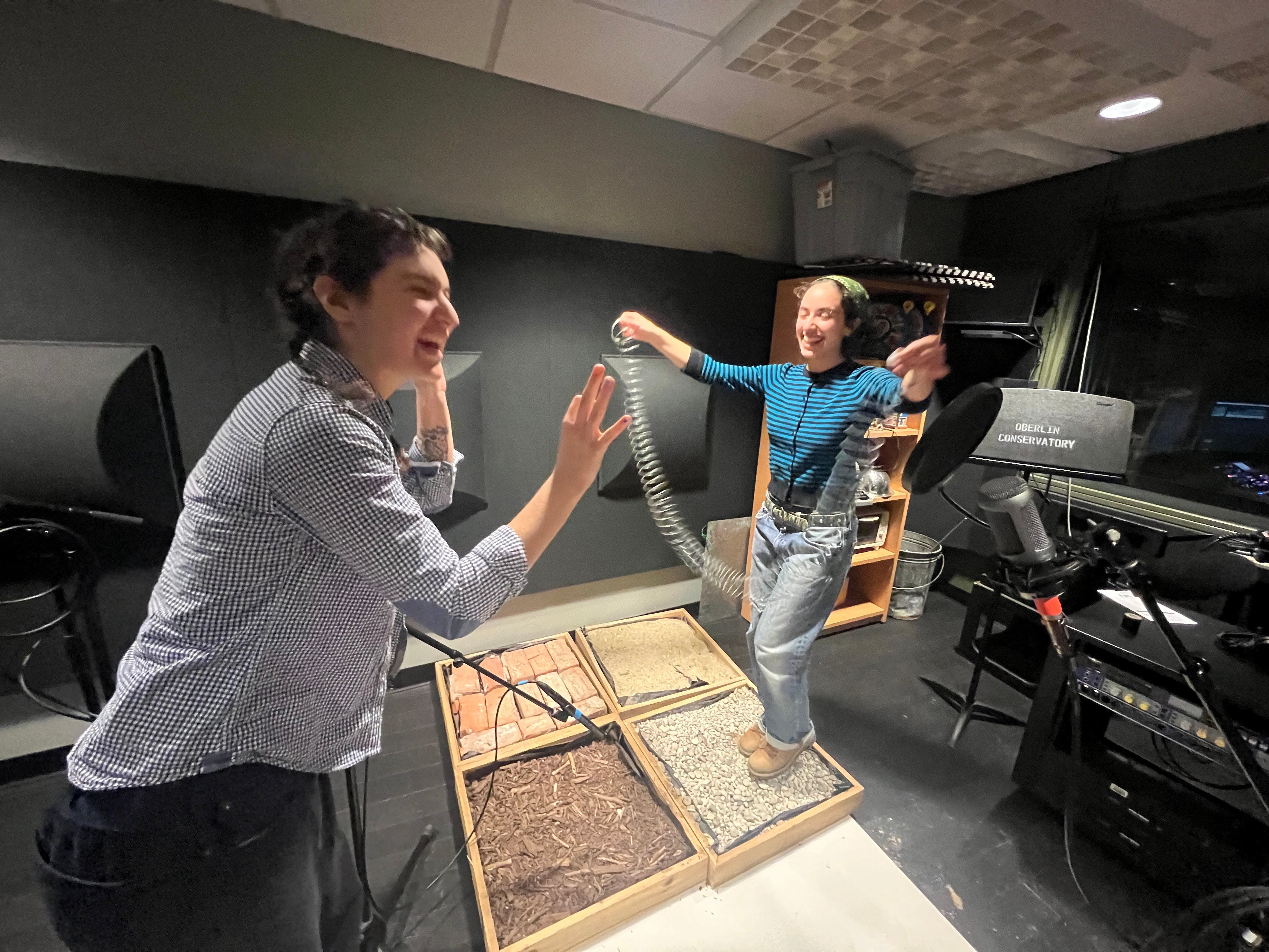 Students with slinkies and other tools making sound.