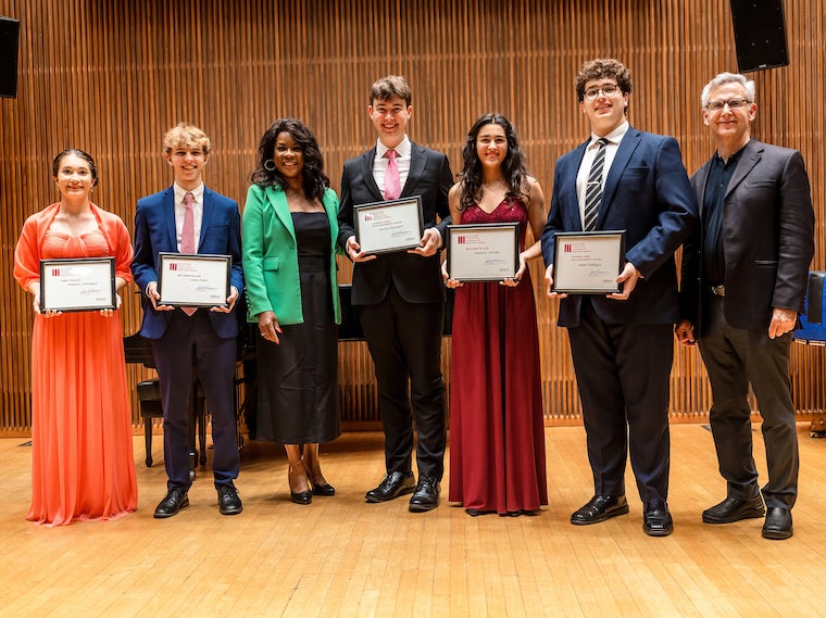 Group of five young singers stand with Denyce Graves and Salvatore Champagne on Kulas stage