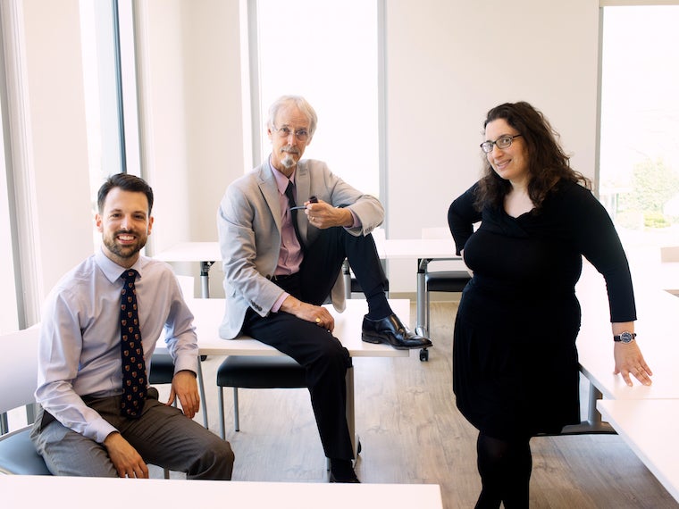 three faculty in meeting room