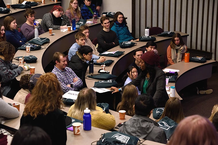 President Ambar engages with students in a lecture hall.