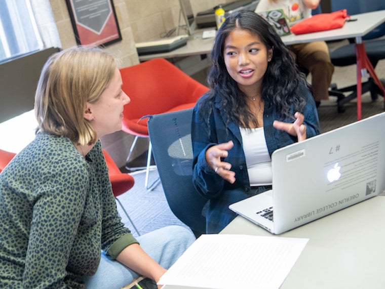 A student and professor discuss an assignment.