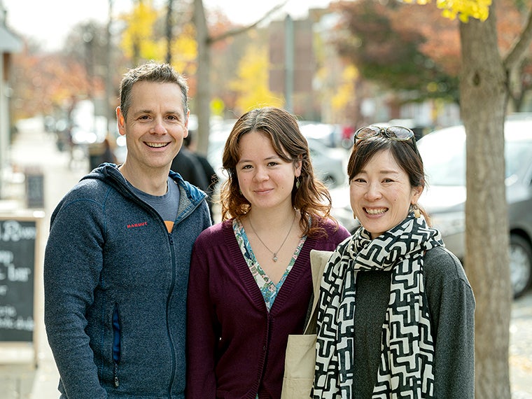 Student and family pose for photo smiling