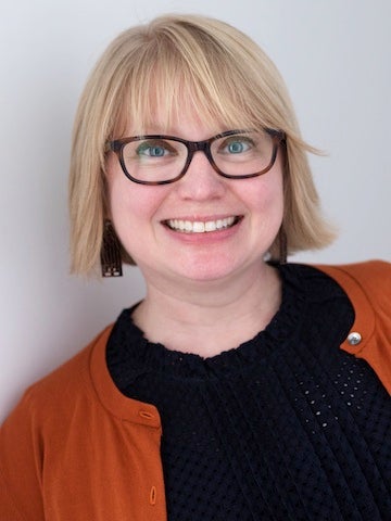 Christie Parris in dark shirt and red sweater.