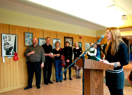 Students speaking at a podium in the Science Center corridor 