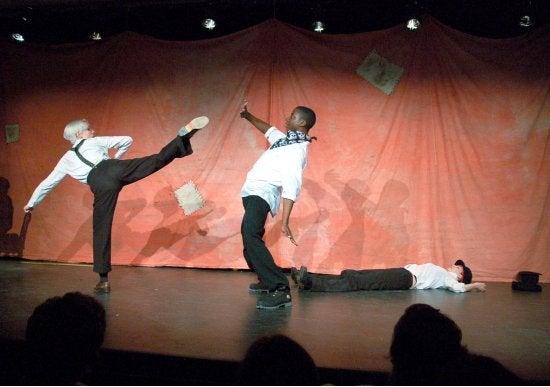 Three performers fighting on stage