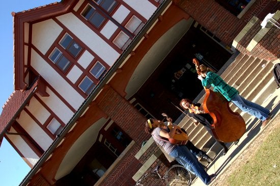 Musicians playing in front of Keep coop