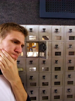 The author posing for a selfie in front of an empty mailbox. His hand rests on his chin and he has a contemplative look