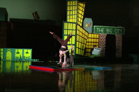 Two performers do acrobatics