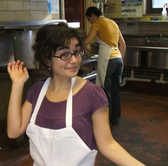 Student posing for the photo wearing an apron