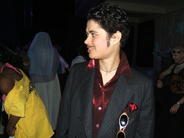 A student dressed as a drag king with a handlebar mustache and a blazer