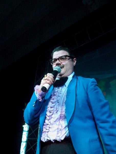 A person dressed as a drag king with a blue blazer 