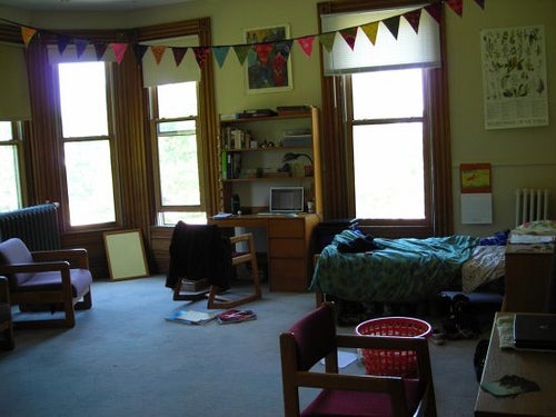A spacious room with several sunny windows.